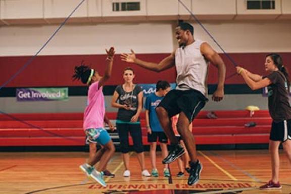 A man and Kids playing basktball
